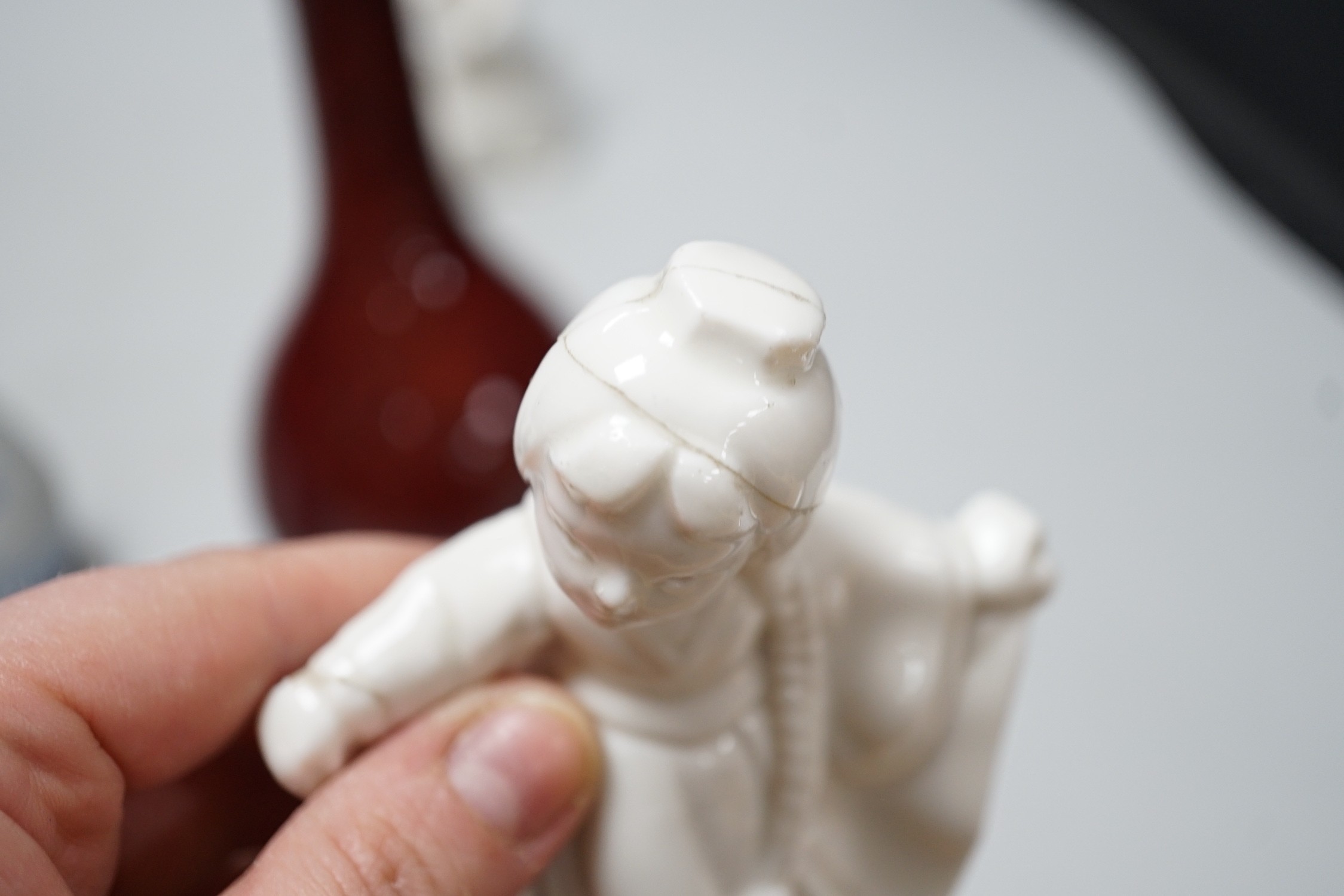A Chinese sang de boeuf bottle neck vase, together with four Chinese miniature vases, three Chinese figures and a Chinese tea bowl, tallest 15cm